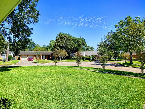 Wonderful curb appeal with petite and mature trees in front yard. View from front door.