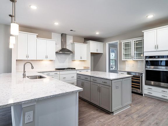 Luxurious Kitchen with Stainless Steel Appliances and Tile Backplash