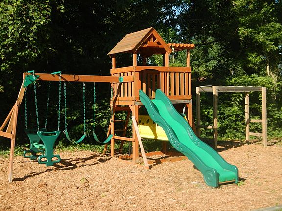 playset in fenced backyard