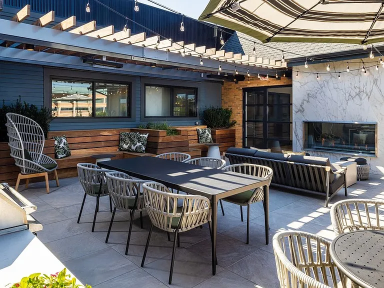 North Building Roof deck with lounge seating, fireplace, and grills