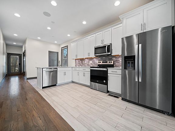 The kitchen is located on the first floor and contains a dishwasher and updated refrigerator and appliances.