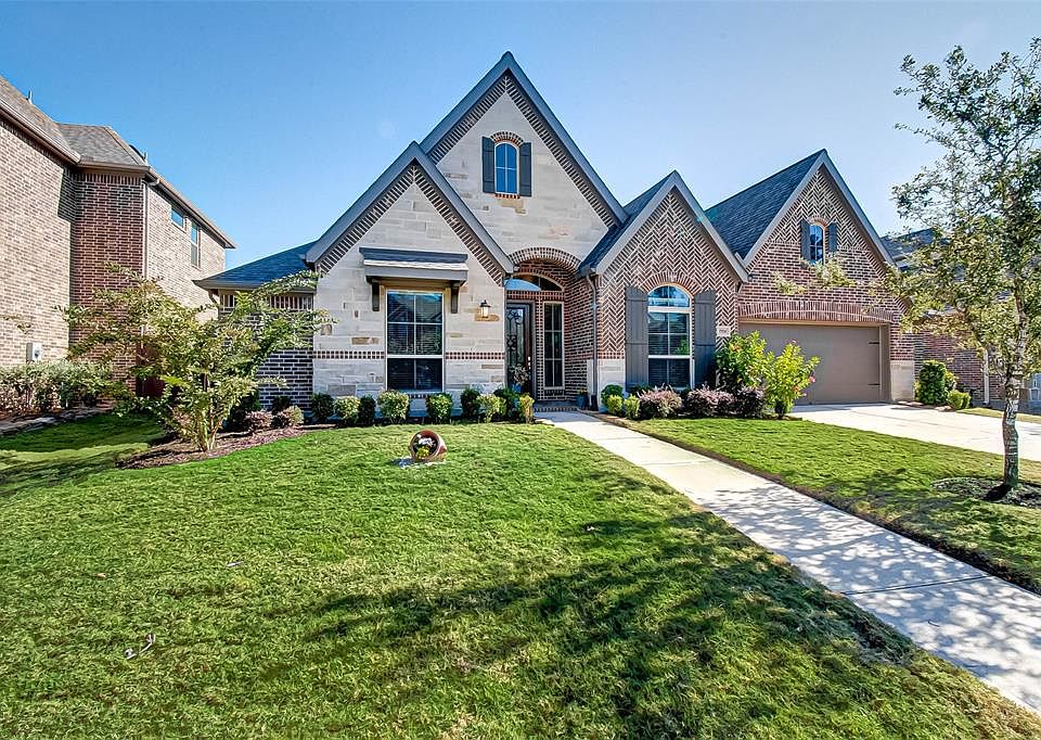 Welcome home! Beautiful brick and stone exterior elevation of this home built by Perry Homes.