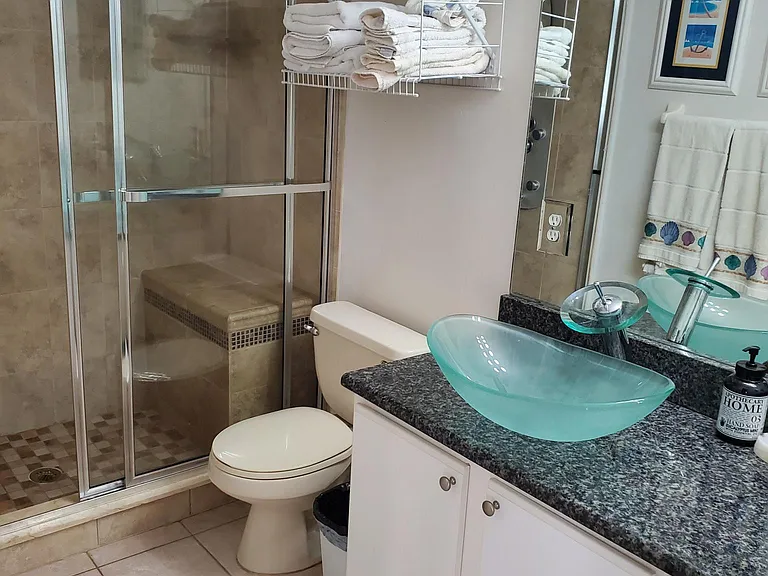 Upstairs bathroom with multi head shower.