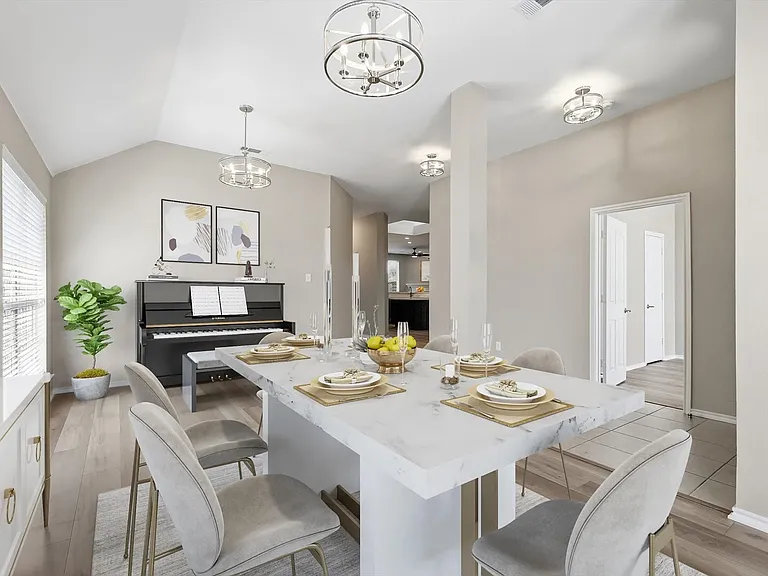 Vaulted ceiling dining area featuring wood-finish flooring and a stone-finish countertop island