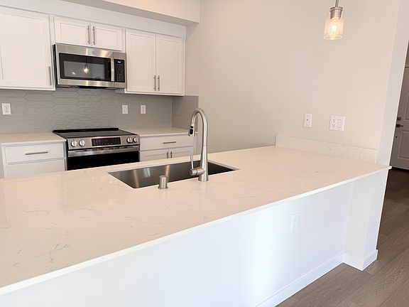 Cook in style with this modern kitchen featuring brand new stainless steel appliances. Sleek, functional, and ready for your culinary creations!
