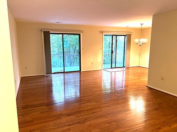 Living and dining areas with double sliders leading to large (8' x 24') composite deck overlooking woods.