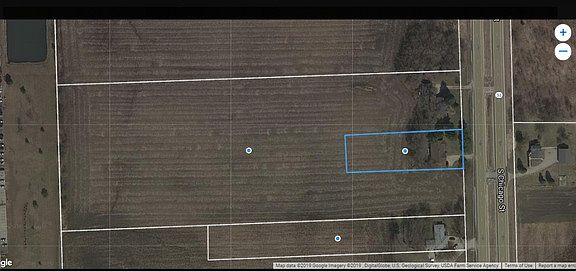 Subject property is outlined in blue.  Dollar Tree is to the left side of the photo, Chicago Street to the right.