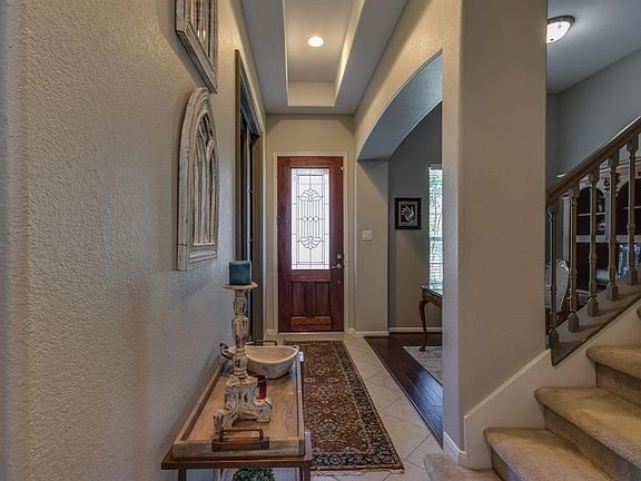 As you enter the home you will notice the soaring ceiling, architectural details of the arched entrance to the study and custom decorative pocket doors.