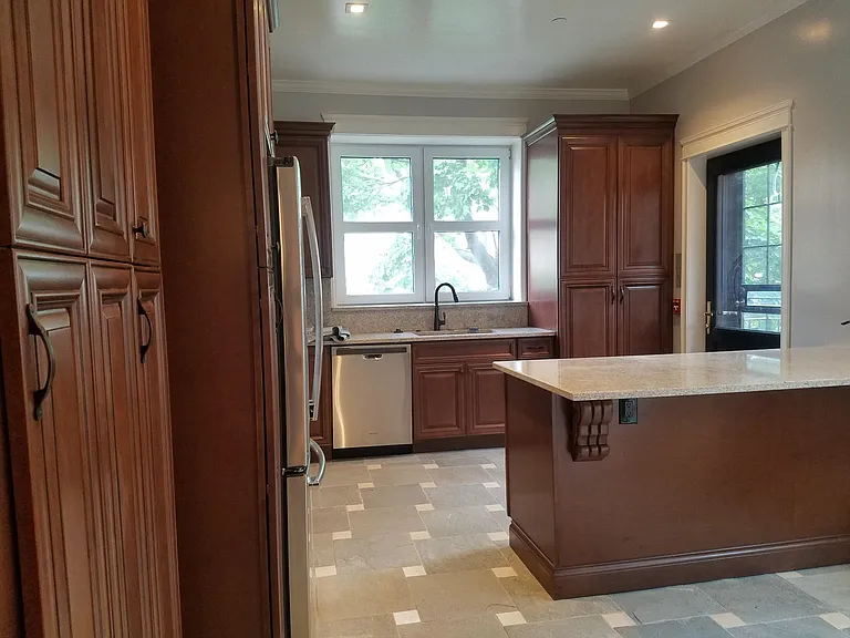 Laundry in tall cabinet by rear door to deck. Wired for data and TV at the peninsula. Dishwasher, double SSTL sink with gooseneck spray faucet, garbage disposal. Beautiful stone floor.