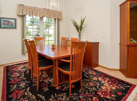 The formal dining area, with windows overlooking the yard and street.