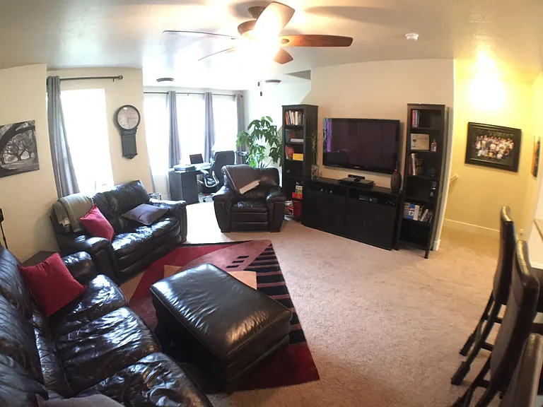 Photo before the flooring was replaced -- showing an example of the furnished living room.