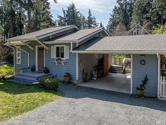 Whoever built this home put some love into it.  Handy little pull in carport with storage cabinet and storage closet on the right.