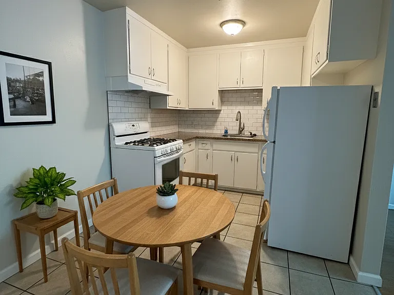 Kitchen of the 2BR unit, but seen with furniture