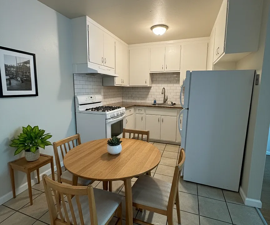 Kitchen of the 2BR unit, but seen with furniture