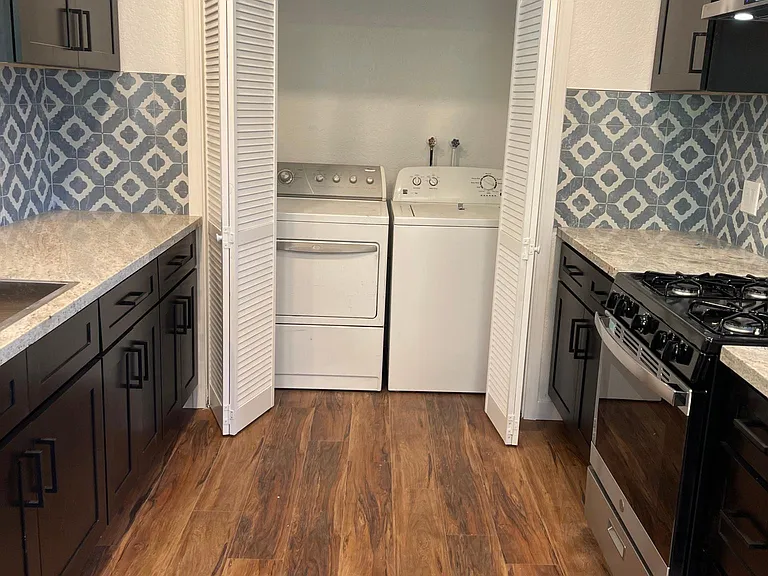 Washer and dryer in unit in kitchen.