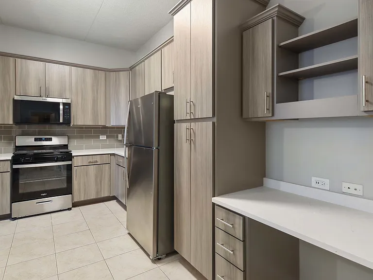 Modern kitchen with built-in desk and sleek storage