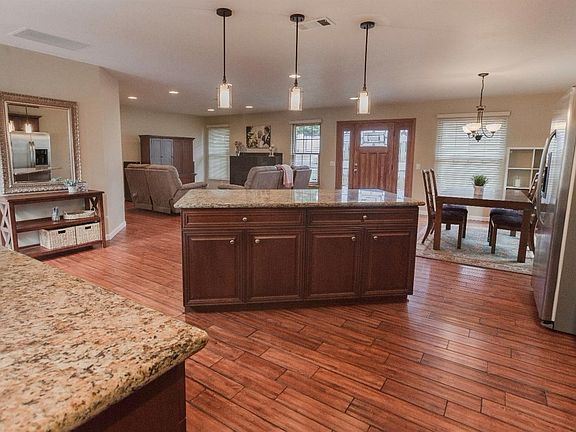 The spacious open concept floor plan is perfect for entertaining and creates a feeling of warmth and sophistication.