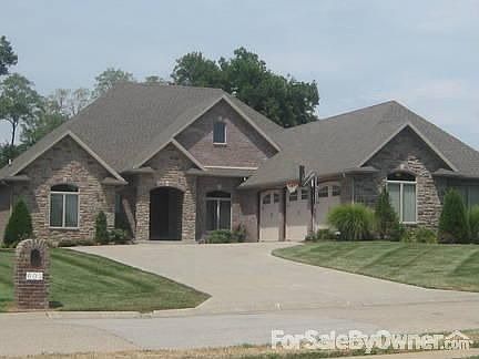 All brick and stone : In ground automatic sprinkler keeps your lawn looking lush and green