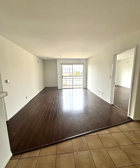 Bright living room with large bedrooms on either side for privacy.