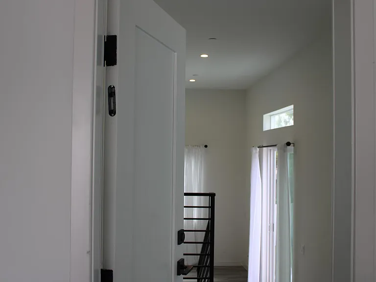 standing in garage looking into the landing area of home.