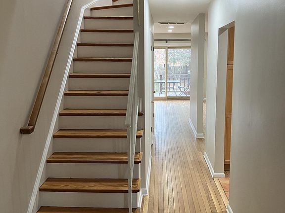 main hallway and stairs to second floor (view of kitchen entry to right)