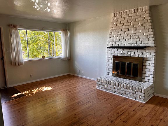 Another view of the spacious living room. A row of trees along the side of the house color the view. The first floor is usually pretty cool even on hot summer days.