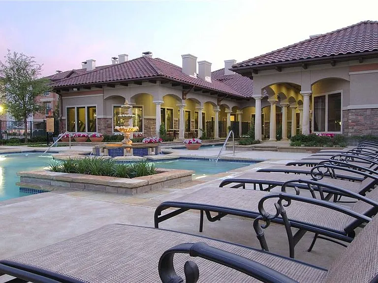 Gorgeous Swimming Pool surrounded by landscaping. Comfortable lounge chairs.