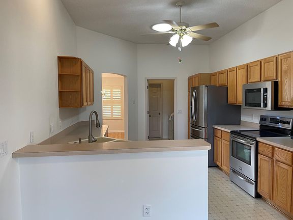 Large kitchen with abundant storage and stainless steel appliances. Pantry boasts custom pull-out drawers.