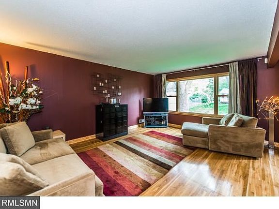 Family room on the main level looks over the back yard. Note the hardwood floors.