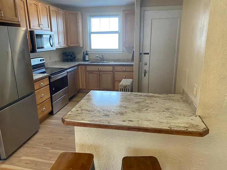 View into kitchen with the penisula visible.