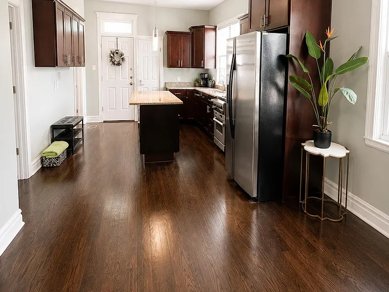 Spacious kitchen with a center island, ample dark-wood cabinetry, and stainless steel appliances plus generous prep space.