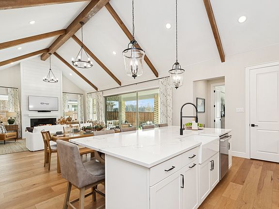 Kitchen with vaulted ceiling and stained ceiling beams