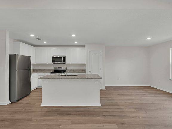 The dining room is open to the kitchen and family room.