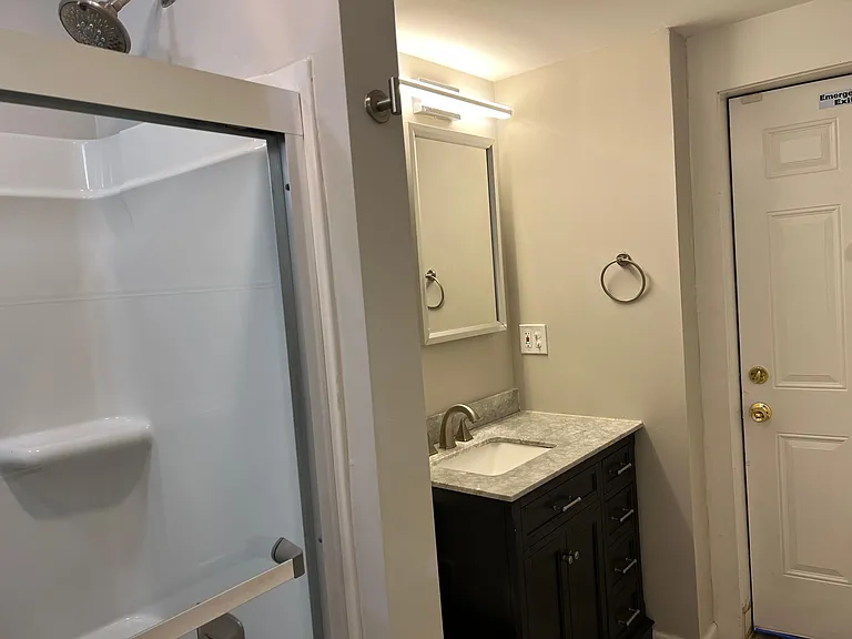 Bathroom with tub shower and rear exit to rear interior courtyard