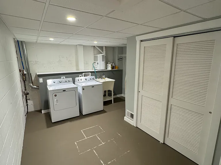 Laundry room in basement with washer/dryer