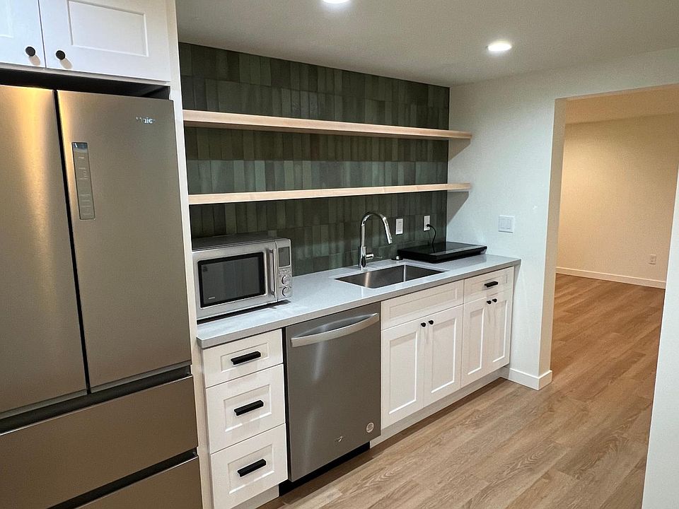 Stainless Steel appliances and designer open shelving