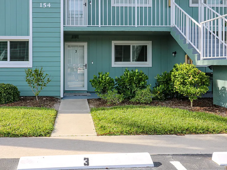 Front door and patio. Dedicated parking spot #3 for this condo.