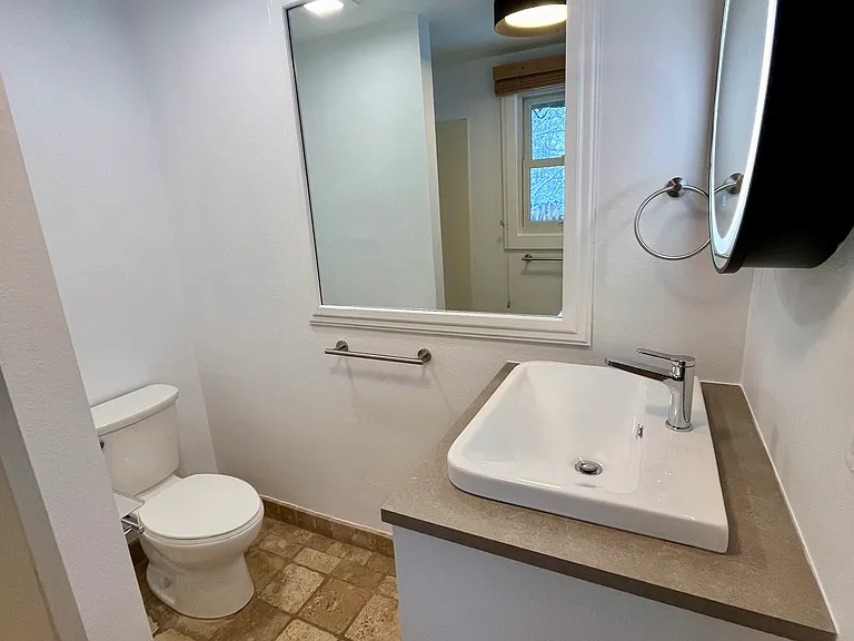 Primary bath with shower and illuminated medicine cabinet mirror
