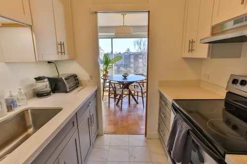 A compact but very functional cooking space, looking out on the dining room and First Hill Park. - 1221 Minor Ave #605