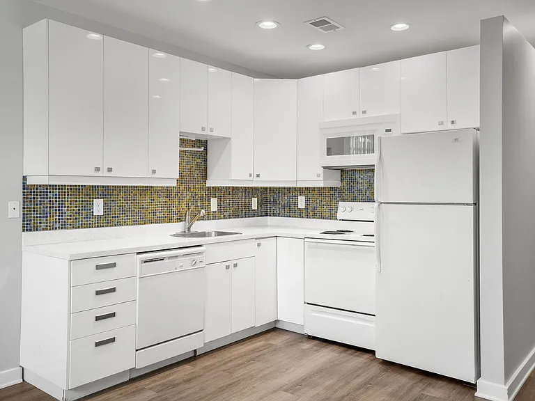 Our Apartment Kitchen with White Cabinets at Sleek Lofts Apartments in Denver, Colorado