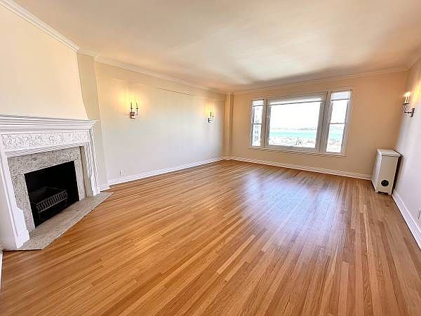 Unit #303 massive living room with wood burning fireplace!