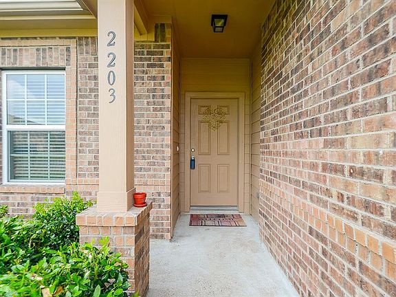 This charming front porch is a perfect spot for your sun-loving flowers!