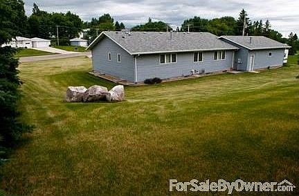 Back of House : -Back yard has character with two apple trees and many evergreens -Garden spot