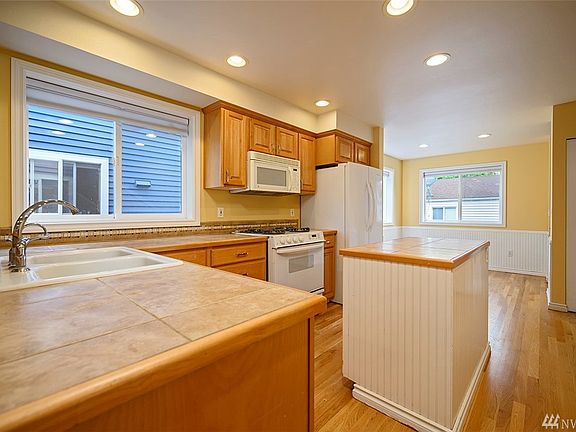 Kitchen with recess lights opens to dining room