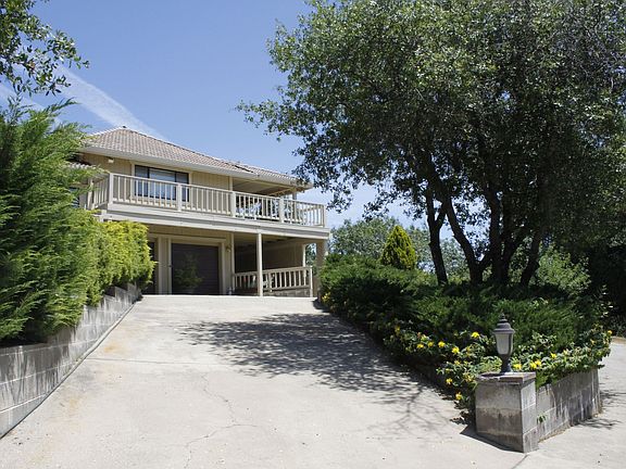 Concrete circular drive and inviting decks.
