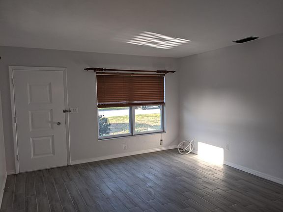 Living room as you enter. View is from kitchen to front of house.