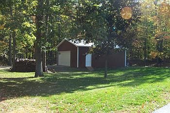 Newer pole barn with high overhead door, perfect for boat storage