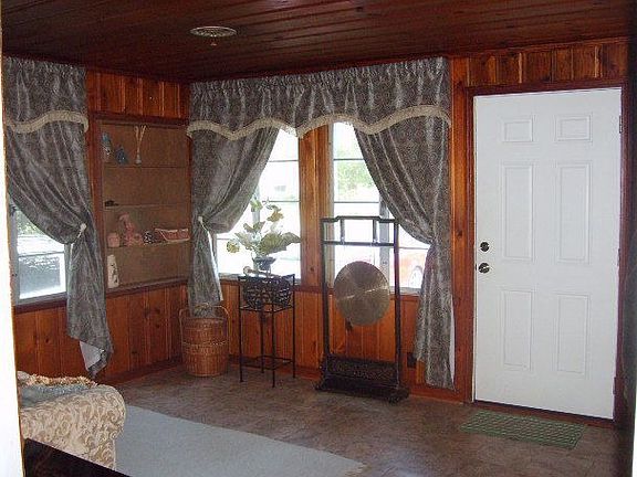 LIVING ROOM WITH KNOTTY PINE PANELING