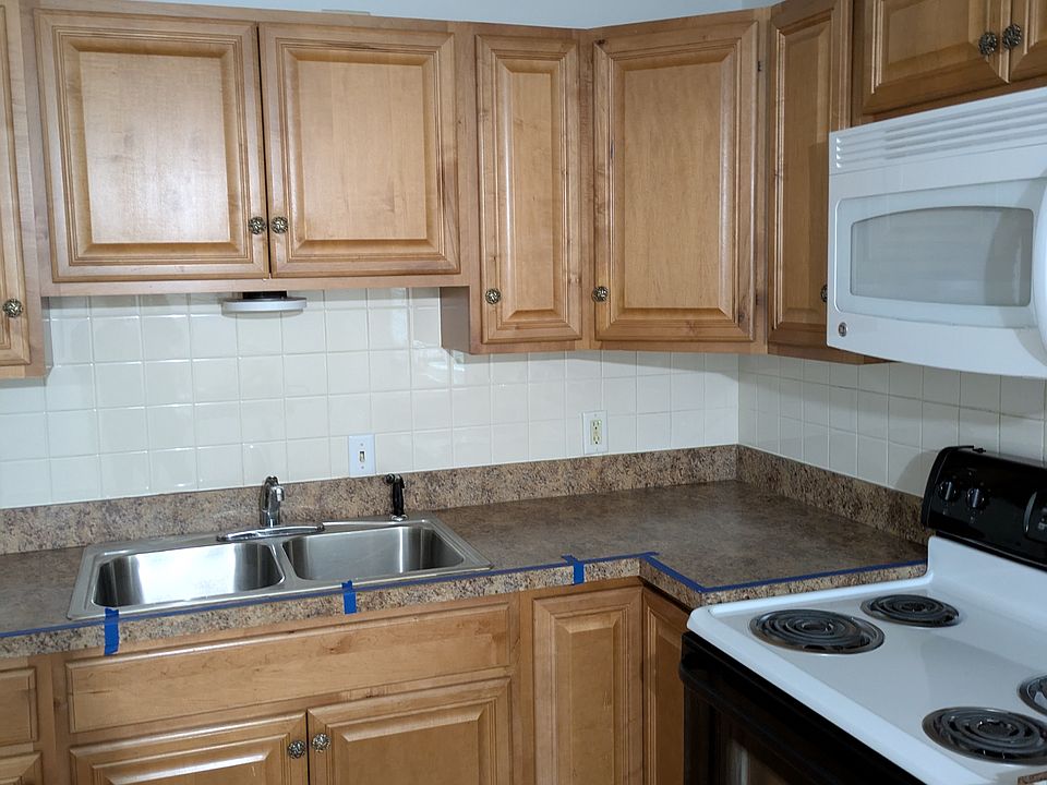 Kitchen area with ample cabinet space and newer counter top