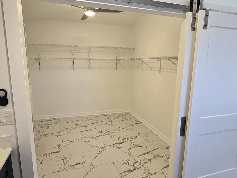 Large master walk in closet with barn doors.